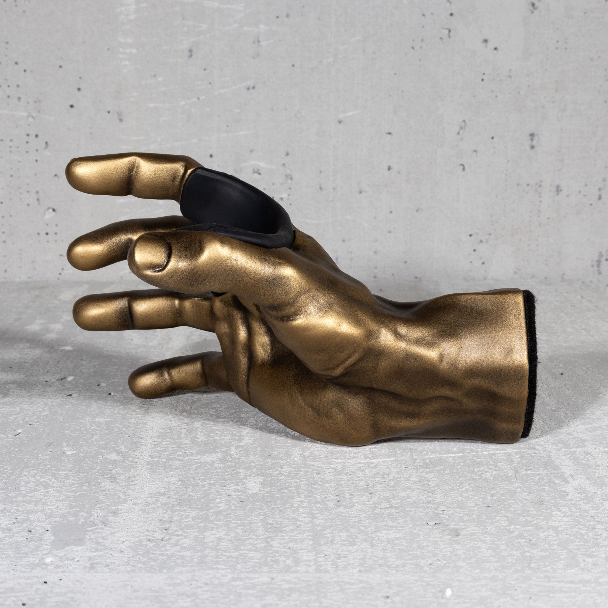 Inside view of gold hand guitar hooks for wall. 