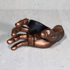 Copper hand guitar hanger wall hook frontview on grey background.