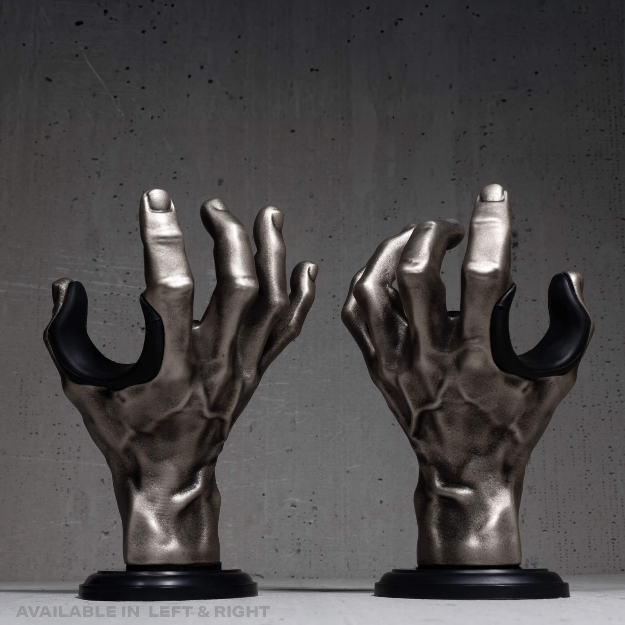 Pair of hand guitar hangers silver on dark grey wall.