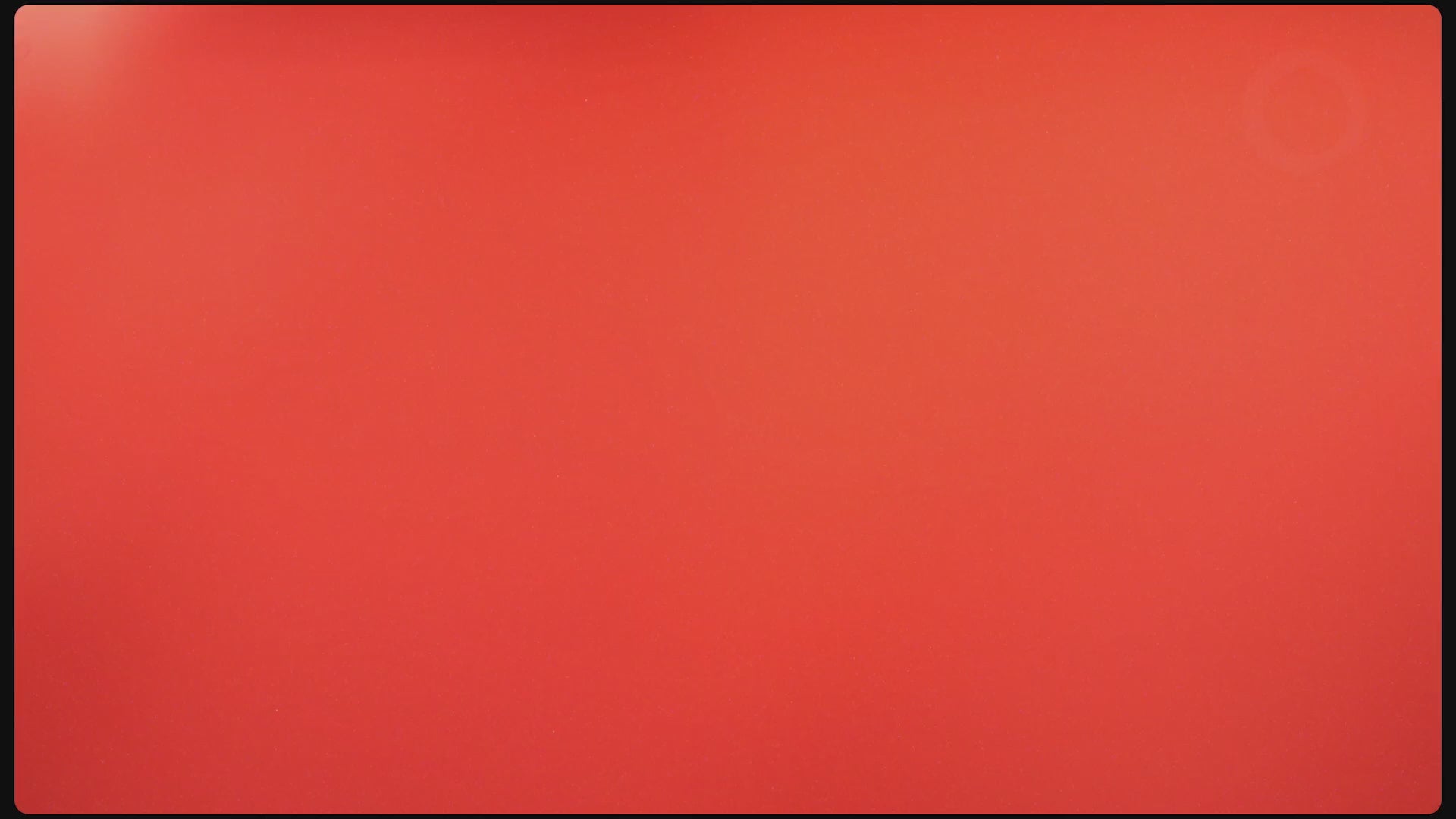Multiple guitars and bass guitars being hung on the wall with guitar hangers shaped like hands. 