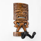 Ukulele display hook in brown and shaped like a tiki man. 